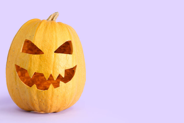 Jack-O-Lantern pumpkin on lilac background - Photo, Image