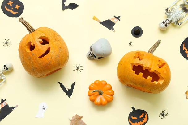 Carved Halloween pumpkins with decor on beige background - Photo, Image
