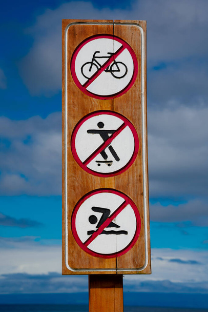Wooden sign with forbidden activities. Frutillar Bajo, Chile - Photo, Image