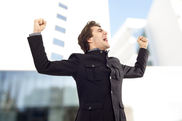 Businessman with arms up celebrating his success - Photo, Image