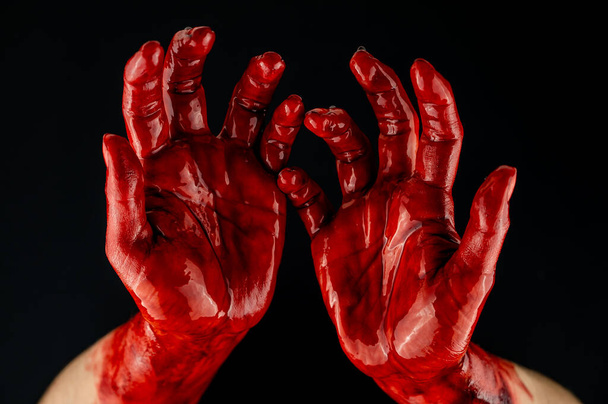 Womens hands in blood on a black background - Фото, изображение