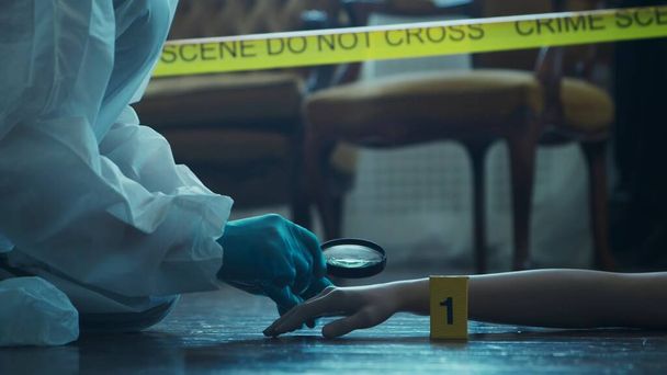 Detective Collecting Evidence in a Crime Scene. Forensic Specialists Making Expertise at Home of a Dead Person. The Concept of Homicide Investigation by Professional Police Officer. - Фото, изображение
