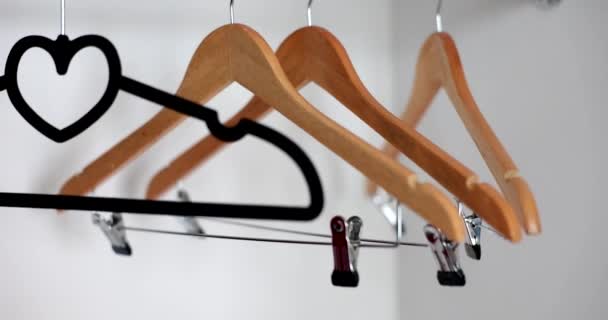 Many empty hangers hanging in closet closeup 4k movie slow motion. Economic crisis empty store shelves concept - Footage, Video