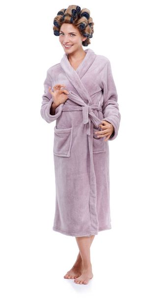 Making pretty. Studio shot of a woman in a bathrobe and curlers - Foto, immagini