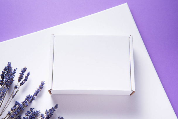 White cardboard box decorated with lavender flowers - Φωτογραφία, εικόνα