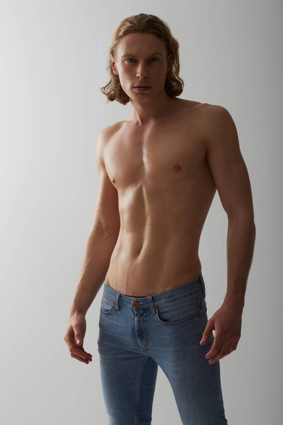 Hes got a handsome style. Studio shot of a young man with a bare chest - Фото, изображение