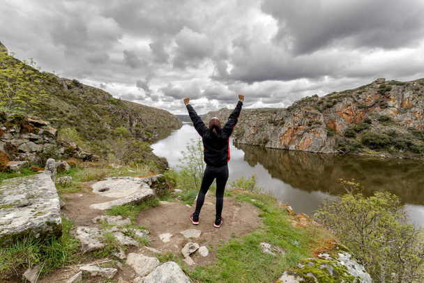 Hiker woman standing with hands up in The Arribes del Duero Natural Park. Spain - Fotó, kép