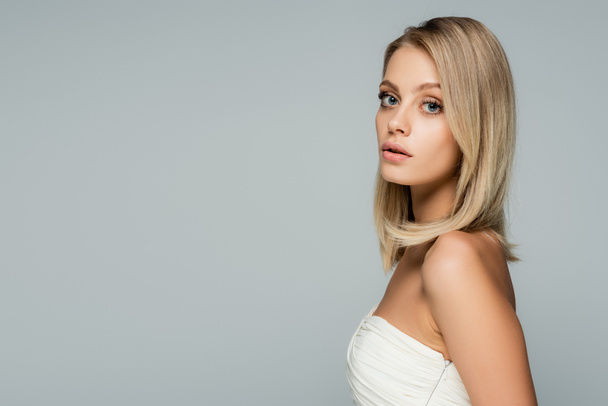 young blonde woman with natural makeup looking at camera isolated on grey - Fotoğraf, Görsel