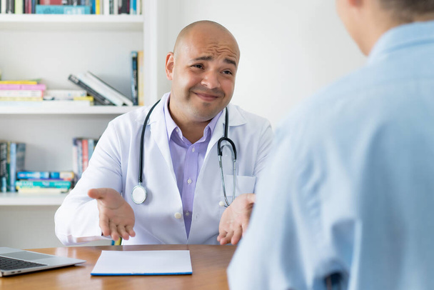 Doctor talking with patient about cancer surgery at office of clinic - Photo, Image