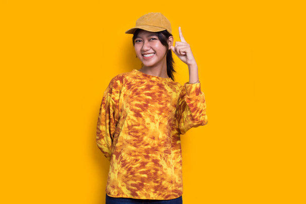 young beautiful asian woman thinking idea isolated on yellow background - Photo, image