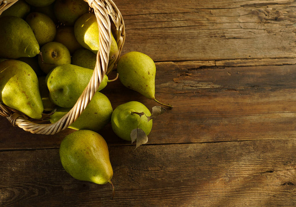 Pears on a wooden background. Fruit harvest. Autumn still life. Pear variety Bera Conference. - Foto, Imagem