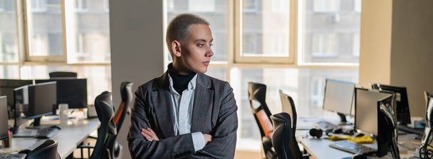 Business woman with short haircut in empty office - Фото, изображение