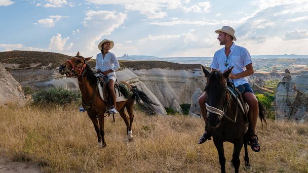 feliz jovem casal em férias na Turquia Kapadokya equitação nas montanhas no fundo da Capadócia Goreme. Passeios a cavalo na Capadócia - Foto, Imagem