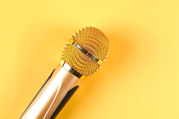 golden microphone isolated on yellow background close u - Photo, Image