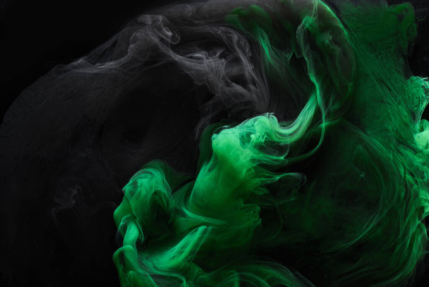 Black green smoke abstract background, acrylic paint underwater explosion, swirling ink - Photo, image