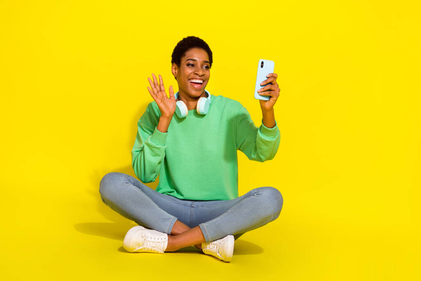 Photo of friendly funky short hair person dressed casual pullover video conference modern device isolated yellow color background. - Foto, imagen