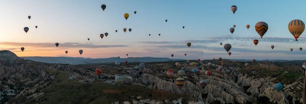 Sunrise with hot air balloons in Cappadocia, Turkey balloons in Cappadocia Goreme Kapadokya, and Sunrise in the mountains of Cappadocia.  - Φωτογραφία, εικόνα