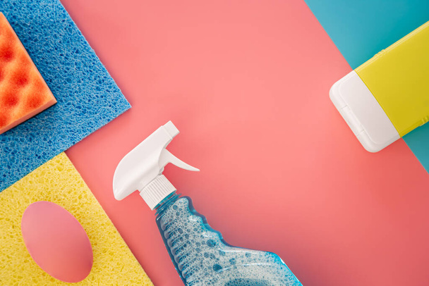 House cleaning products on pink background, flat lay, minimalism. - Foto, Imagen