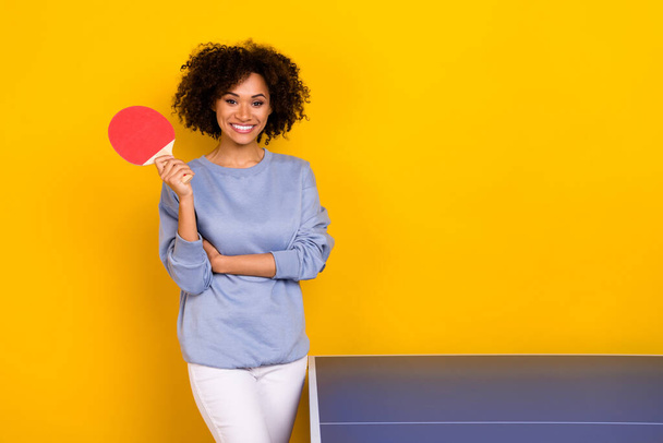 Photo of cute adorable curly girl dressed blue pullover ready playing table tennis isolated yellow color background. - Photo, Image