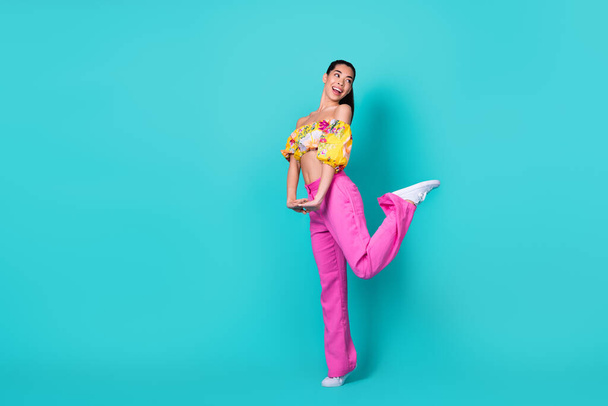 Full length photo of lovely millennial brunette lady look promo wear top pants boots isolated on teal background. - Φωτογραφία, εικόνα