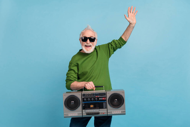 Portrait of funny grandparent have fun hold vintage boombox good mood isolated on blue color background. - Fotó, kép