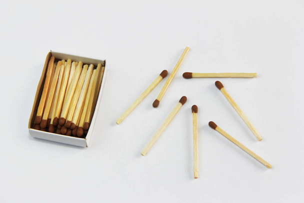 yellow wooden matches for lighting in a cardboard box on a white background - Фото, зображення