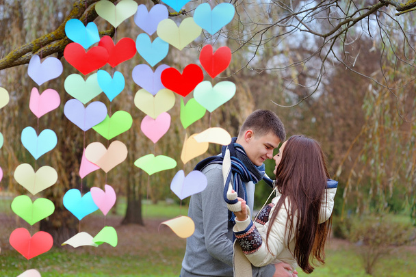 couple in love on Valentine's Day in the Park with hearts - Photo, Image