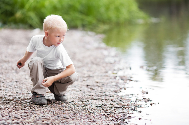 Boy near the river - Фото, изображение
