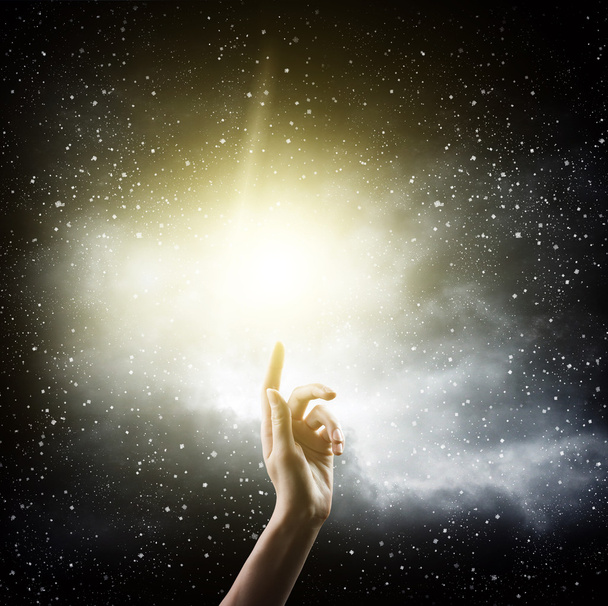 Hand over starry sky background - Фото, изображение