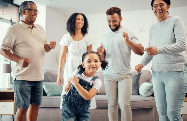 Happy, family and dancing in playful living room fun together with entertainment in happiness at home. Group of people in relationship bonding, smiling and joyful funny dance at the house. - Фото, зображення