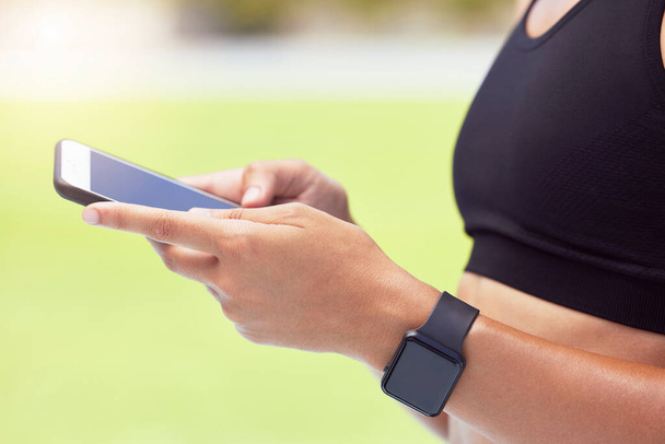 Exercise, smartwatch and woman with phone on fitness app for outdoor workout. Technology, innovation and sports on smartphone with data and digital information for health and wellness while training - 写真・画像