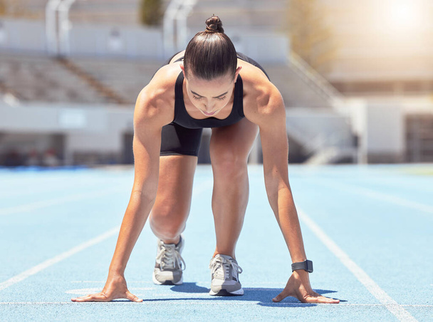 Motivation, energy and runner start training at outdoor track, ready to practice go. Health, power and fitness goal by professional woman athlete with strong mindset prepare for speed, cardio sprint. - Foto, Imagem
