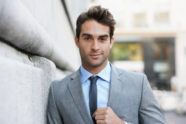 Working in the city. A handsome young businessman looking at the camera - Foto, Imagen