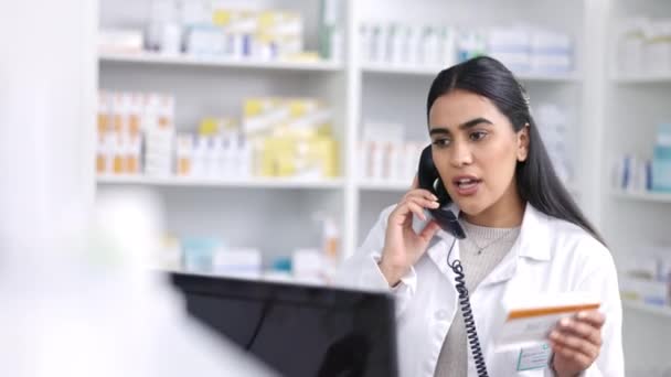 Pharmacist talking on telephone, computer and help customer service for prescription medicine, retail healthcare and medical pills. Young woman speaking phone call in pharmacy, chemist and drugstore. - Footage, Video