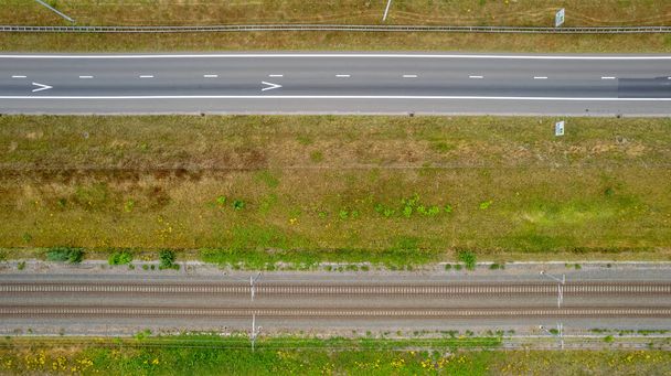 Aerial view of highway road junction. Highways, bridge and green fields on the outskirts of the city. in Belgium Transport concept. High quality photo shot by a drone - Photo, Image