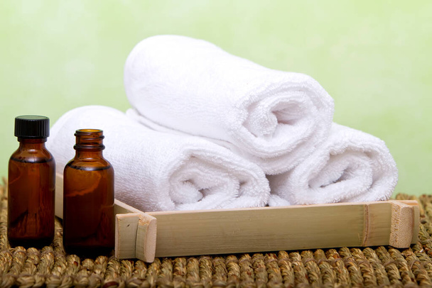 Clean white spa towels and fragrance sticks - Foto, Imagen