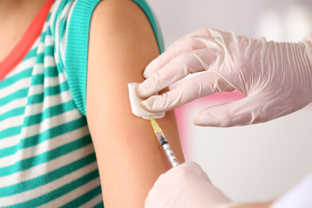 Doctor vaccinates a patient - Фото, изображение