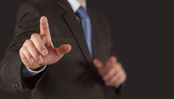 Businessman hand pressing an imaginary button on virtual screen - Photo, Image
