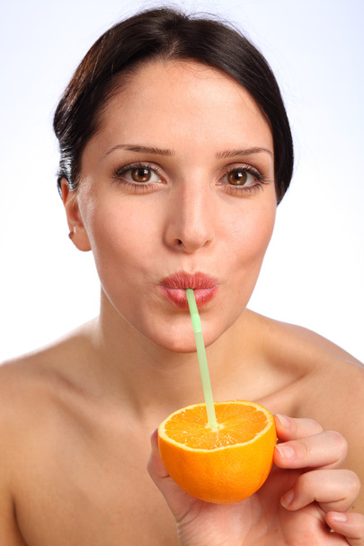 Vitamin C orange fruit juice drink for young woman - 写真・画像