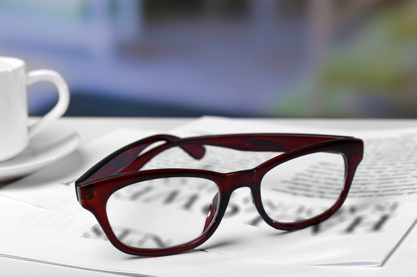 Glasses and newspapers close up - 写真・画像
