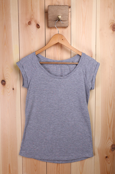 Female t-shirt on hanger - Fotoğraf, Görsel