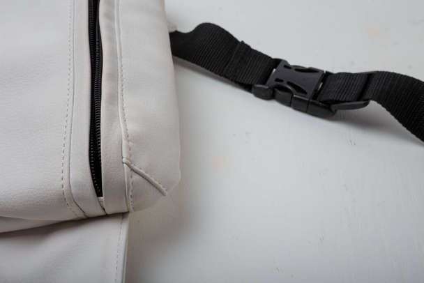 Eco leather waist bag with black zipper on white background, close up shot - Photo, Image