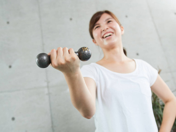 Woman training with dumbbells at home - Photo, Image