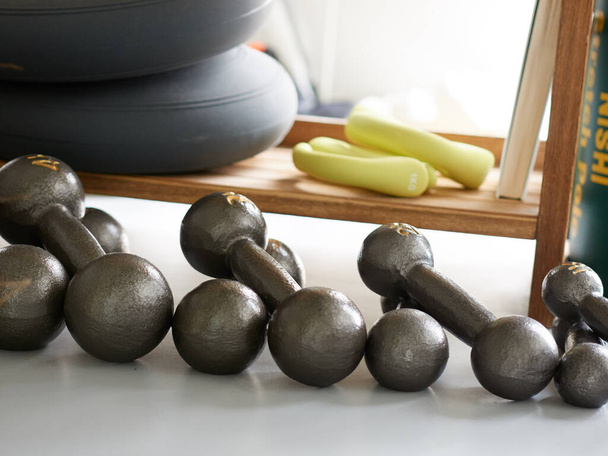 Dumbbells lined up in a training gym - Photo, Image