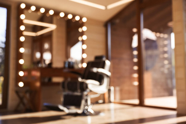 Blurred view of stylish barbershop interior with hairdresser workplace - Photo, Image