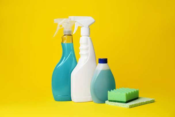 Cleaning supplies and tools on yellow background - Fotó, kép