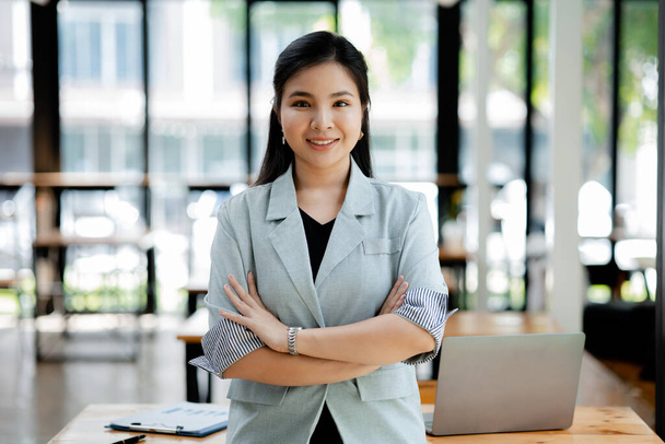 Portrait of a young beautiful Asian woman in a office room, concept image of Asian business woman, modern female executive, startup business woman, business leader woman. - Photo, Image