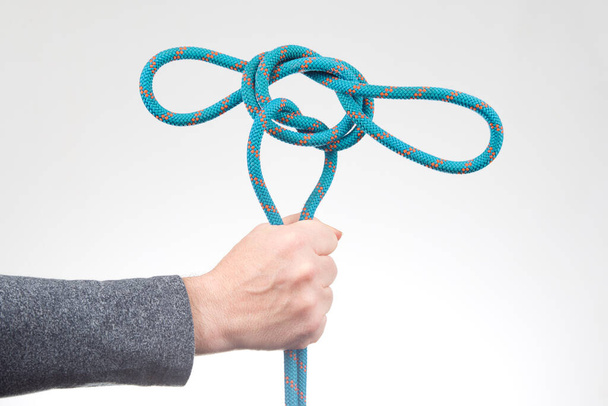 hand holds colored rope for climbing equipment. item for camping and climbing - Photo, Image