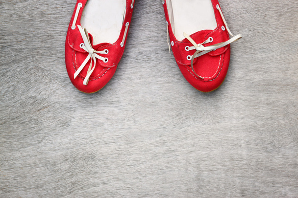 Top view of red worn woman shoes over wooden textured background. instagram style filter - Foto, afbeelding