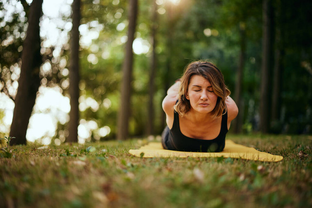 Yogi woman practicing yoga in nature in the forest. - Zdjęcie, obraz